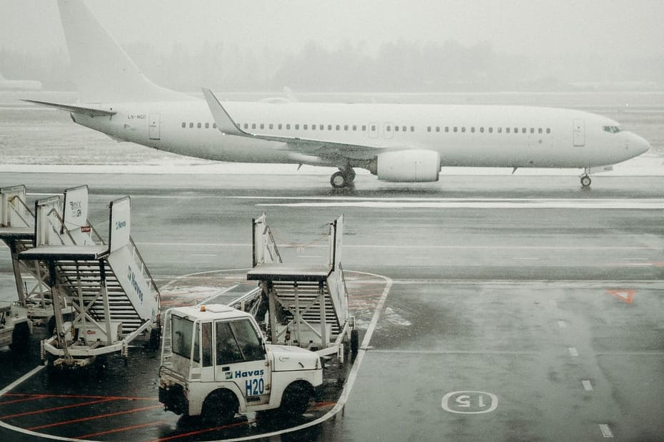 an airplane and airport workers around it