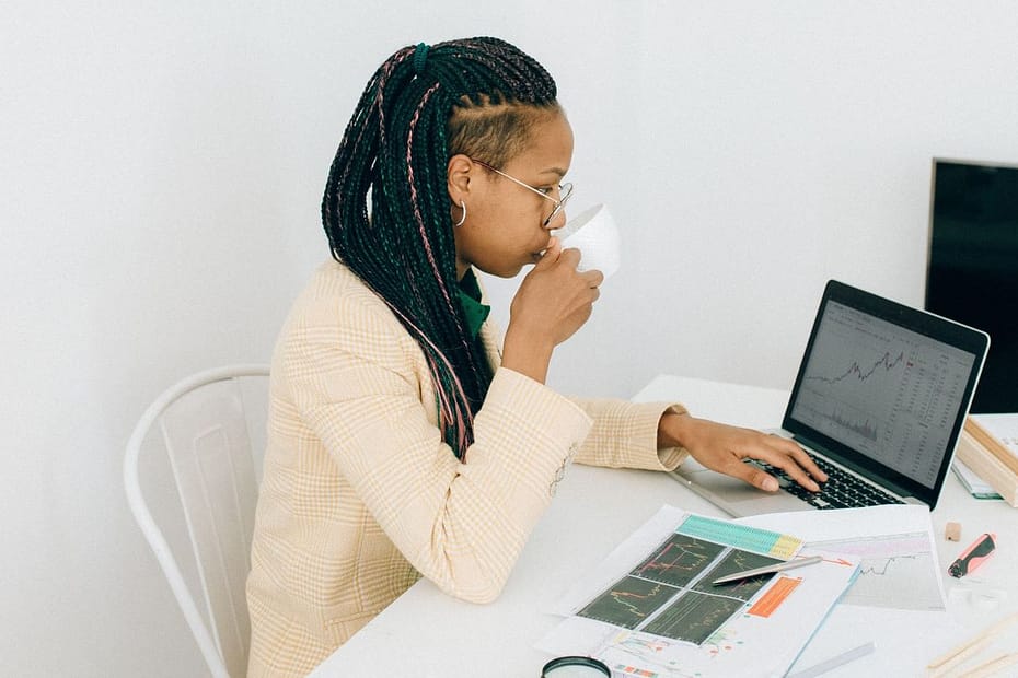 young person staring at computer and drinking from a mug- what is a computer aided facility management